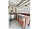 Outdoor kitchen with grill, mini fridge, and brick accents at 168 Rue Des Chateaux, Tarpon Springs, FL 34688