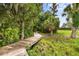 Charming wooden path winding through lush landscaping, creating a tranquil escape at 168 Rue Des Chateaux, Tarpon Springs, FL 34688