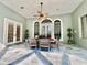 Patio with dining table set for six and arched windows at 168 Rue Des Chateaux, Tarpon Springs, FL 34688