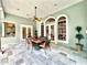 Covered outdoor patio features slate tile and an outdoor dining set, with views of the backyard at 168 Rue Des Chateaux, Tarpon Springs, FL 34688