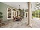 Stylish outdoor patio with comfortable seating and elegant columns, perfect for dining and entertaining at 168 Rue Des Chateaux, Tarpon Springs, FL 34688