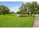 Scenic community pond featuring a fountain, surrounded by a beautifully landscaped lawn at 168 Rue Des Chateaux, Tarpon Springs, FL 34688