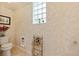 Charming powder room featuring decorative walls and an ornate metal storage rack at 168 Rue Des Chateaux, Tarpon Springs, FL 34688