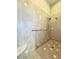 Shower stall with tile walls, seating, and grab bars at 168 Rue Des Chateaux, Tarpon Springs, FL 34688