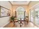 Cozy sitting area with a large window, two chairs, and a decorative table at 168 Rue Des Chateaux, Tarpon Springs, FL 34688