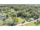 Aerial view of property showing house surrounded by trees and open space at 35204 Ponderosa Rd, Zephyrhills, FL 33541