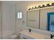 Bright bathroom features double sink vanity with modern fixtures and large mirrors with Hollywood lighting at 4336 Bayside Village Dr # 201, Tampa, FL 33615