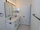 Well-lit bathroom with double sink vanity, modern fixtures, and quartz countertops at 4336 Bayside Village Dr # 201, Tampa, FL 33615