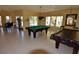 Resident game room with billiard tables, lounge seating, and bright views at 4336 Bayside Village Dr # 201, Tampa, FL 33615