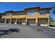 Exterior view of a well-maintained building with multiple garages and stucco facade under a clear blue sky at 4336 Bayside Village Dr # 201, Tampa, FL 33615