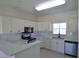 Modern kitchen features stainless steel appliances, white cabinets, and sleek countertops at 4336 Bayside Village Dr # 201, Tampa, FL 33615