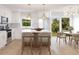 Modern kitchen with white cabinets, marble countertops, and an island with seating at 0 Trapper John Rd, Weeki Wachee, FL 34614