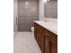 Elegant bathroom with double vanity, gray wall paneling, and marble flooring at 0 Trapper John Rd, Weeki Wachee, FL 34614
