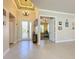 Elegant entryway with tile floors, chandelier, and view to living area at 15810 Cobble Mill Dr, Wimauma, FL 33598