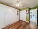Bright bedroom with hardwood floors, large window, and built-in storage at 15810 Cobble Mill Dr, Wimauma, FL 33598