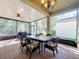 Outdoor screened lanai with dining table and chairs, perfect for relaxing at 15810 Cobble Mill Dr, Wimauma, FL 33598