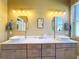 Elegant bathroom with double sinks, quartz countertops, and updated fixtures at 15810 Cobble Mill Dr, Wimauma, FL 33598