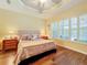 Spacious main bedroom with wood floors and a tray ceiling at 15810 Cobble Mill Dr, Wimauma, FL 33598