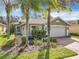 One-story house with a white garage door and landscaped yard at 15810 Cobble Mill Dr, Wimauma, FL 33598