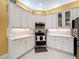 Modern kitchen with white cabinets, stainless steel appliances, and an island at 15810 Cobble Mill Dr, Wimauma, FL 33598