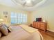 Main bedroom with wood floors, large window, and media cabinet at 15810 Cobble Mill Dr, Wimauma, FL 33598