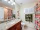 Bathroom with granite countertop, wood cabinets and a shower at 15810 Cobble Mill Dr, Wimauma, FL 33598