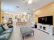 Open living room with a view of kitchen, comfortable seating, and tiled floors at 15810 Cobble Mill Dr, Wimauma, FL 33598