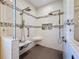Large walk-in shower with multiple shower heads and a built-in seat at 15810 Cobble Mill Dr, Wimauma, FL 33598