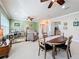 Open concept dining area flows into the living room and features a wood table at 15810 Cobble Mill Dr, Wimauma, FL 33598