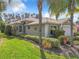 Single-Gathering home with a two-car garage and lush landscaping at 15810 Cobble Mill Dr, Wimauma, FL 33598