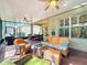 Comfortable screened lanai furnished with wicker seating and a glass-top coffee table at 15810 Cobble Mill Dr, Wimauma, FL 33598
