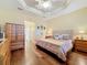Main bedroom with wood floors, walk-in closet, and wood dresser at 15810 Cobble Mill Dr, Wimauma, FL 33598