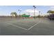 Well-lit tennis courts with seating at 15810 Cobble Mill Dr, Wimauma, FL 33598