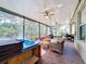 Spacious screened lanai featuring a hot tub and comfortable seating areas at 15810 Cobble Mill Dr, Wimauma, FL 33598