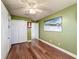 Bright bedroom with wood floors, double doors, and large wall art at 15810 Cobble Mill Dr, Wimauma, FL 33598