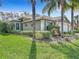 House with palm trees, a two-car garage, and a well-kept lawn at 15810 Cobble Mill Dr, Wimauma, FL 33598
