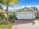 One-story house with a white garage door and landscaped yard at 15810 Cobble Mill Dr, Wimauma, FL 33598