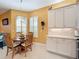 Charming breakfast nook with wood table and chairs, located in the kitchen at 15810 Cobble Mill Dr, Wimauma, FL 33598