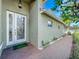 Front entry featuring an etched glass door and brick walkway at 15810 Cobble Mill Dr, Wimauma, FL 33598