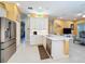 Spacious kitchen with white cabinets, stainless steel appliances, and a large island at 15810 Cobble Mill Dr, Wimauma, FL 33598