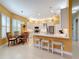 Modern kitchen with white cabinets, stainless steel appliances and breakfast bar at 15810 Cobble Mill Dr, Wimauma, FL 33598
