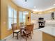 Bright breakfast nook with wood table and chairs near kitchen at 15810 Cobble Mill Dr, Wimauma, FL 33598