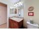Guest bathroom with granite countertop and wood cabinets at 15810 Cobble Mill Dr, Wimauma, FL 33598