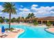 Relaxing pool area with lounge chairs and palm trees at 15810 Cobble Mill Dr, Wimauma, FL 33598