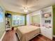 Bright bedroom with hardwood floors, large window, and built-in murphy bed at 15810 Cobble Mill Dr, Wimauma, FL 33598