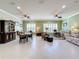 Bright dining room features a spacious layout, large windows, and elegant furnishings at 15810 Cobble Mill Dr, Wimauma, FL 33598