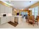 Open kitchen boasts white cabinets, stainless steel appliances, and an eat-in area at 15810 Cobble Mill Dr, Wimauma, FL 33598