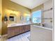 Modern bathroom with double vanity, large shower, and window at 15810 Cobble Mill Dr, Wimauma, FL 33598