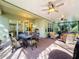 Spacious screened lanai with dining area, seating area, and ceiling fans at 15810 Cobble Mill Dr, Wimauma, FL 33598