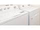 Laundry room with white Whirlpool washer and dryer at 12197 Downy Birch Dr, Riverview, FL 33569